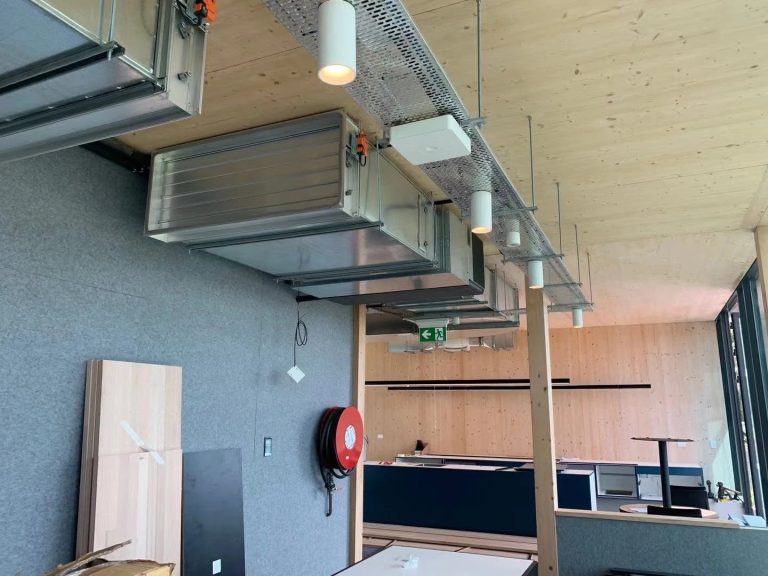 Exposed ductwork and ceiling-suspended fan coil units in the cross-laminated timber Albert Park Office and Depot