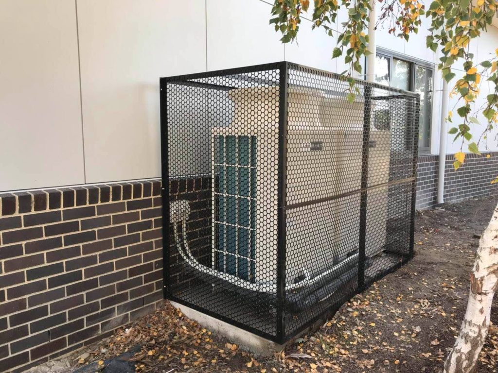 Architectural screen concealing air conditioning condenser units for acoustic and visual amenity