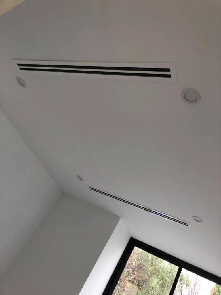 Concealed ducted air conditioning with a flush linear slot diffuser in a designer Melbourne home